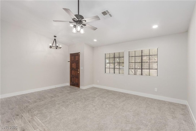 carpeted empty room with ceiling fan with notable chandelier, vaulted ceiling, visible vents, recessed lighting, and baseboards