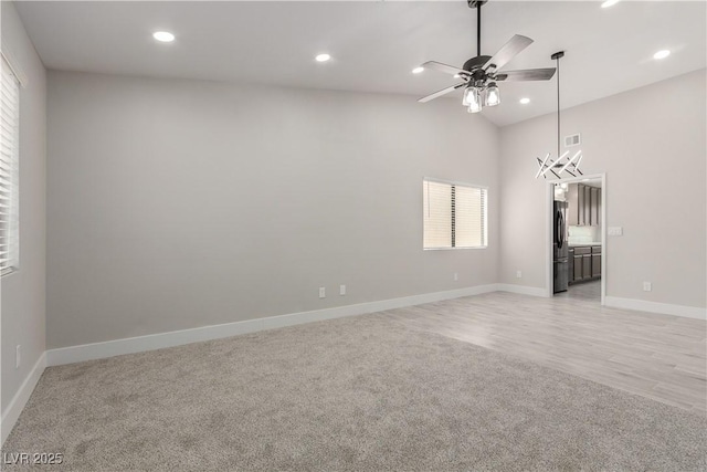 unfurnished room featuring light carpet, recessed lighting, vaulted ceiling, and ceiling fan