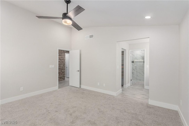 unfurnished bedroom with visible vents, baseboards, vaulted ceiling, and carpet floors