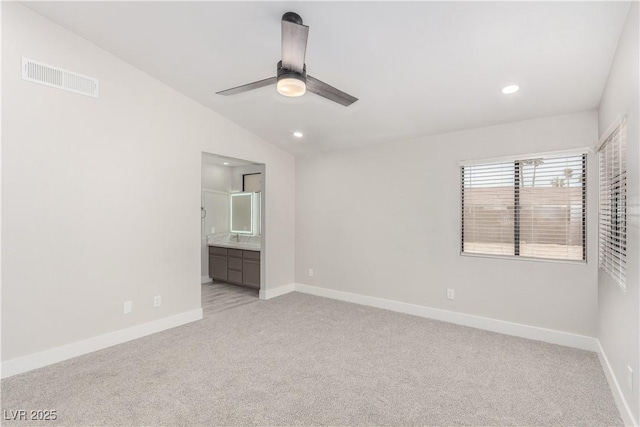 unfurnished bedroom featuring baseboards, vaulted ceiling, light carpet, recessed lighting, and visible vents