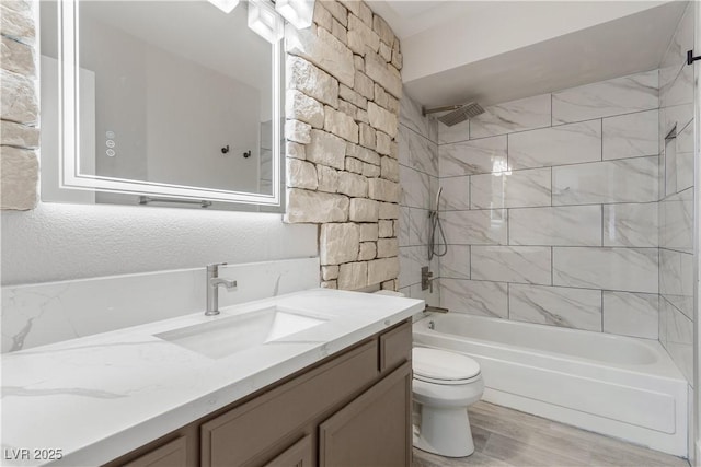 full bathroom with a textured wall, vanity, shower / bathing tub combination, and toilet