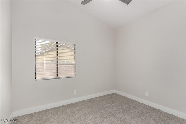 unfurnished room with carpet floors, baseboards, and vaulted ceiling