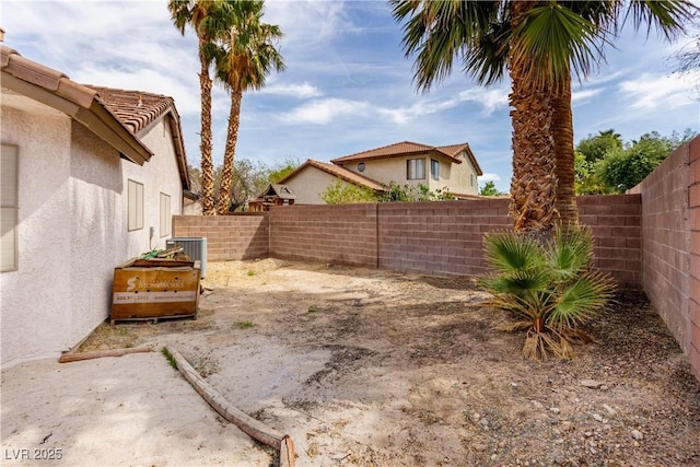 view of yard featuring central air condition unit and a fenced backyard