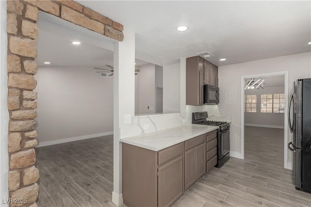 kitchen featuring recessed lighting, ceiling fan with notable chandelier, black appliances, and wood finish floors