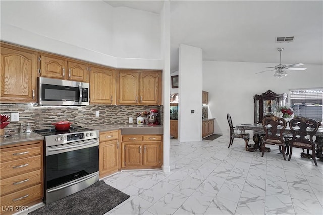 182 Horizon View Dr, Henderson, NV 89015 - kitchen with a ceiling fan, stainless steel appliances, visible vents, decorative backsplash, and marble finish floor