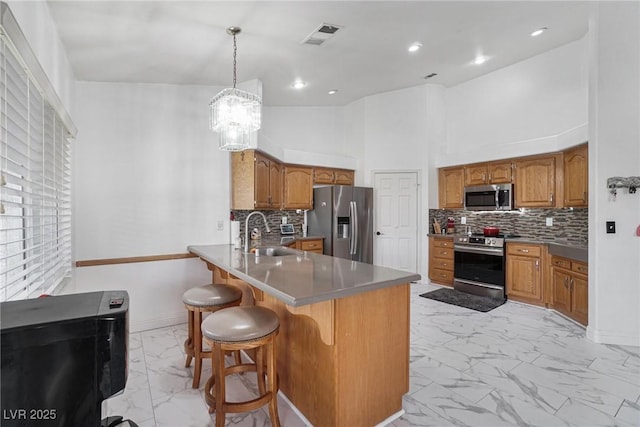 182 Horizon View Dr, Henderson, NV 89015 - kitchen with a peninsula, brown cabinets, a sink, stainless steel appliances, and marble finish floor