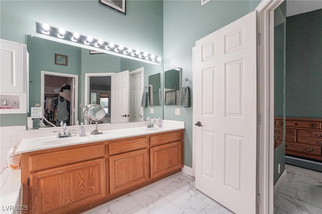 182 Horizon View Dr, Henderson, NV 89015 - full bathroom with double vanity, marble finish floor, a walk in closet, and a sink