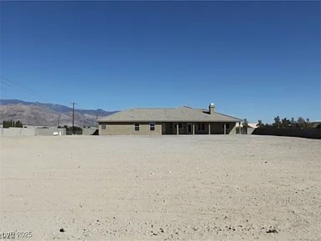 back of house featuring a mountain view
