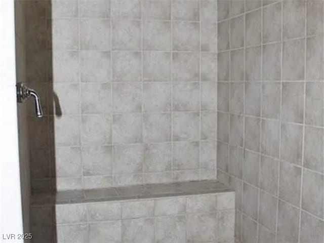 bathroom with tiled shower
