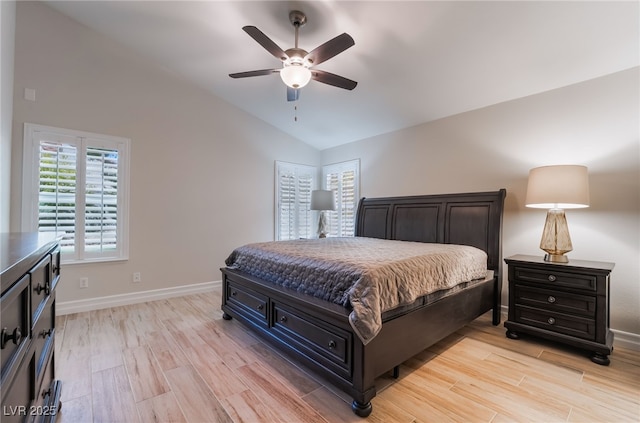 bedroom with light wood-style flooring, ceiling fan, baseboards, and lofted ceiling