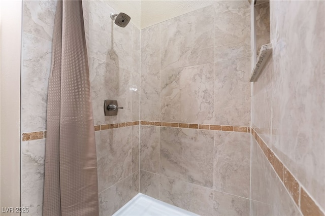 bathroom with a tile shower