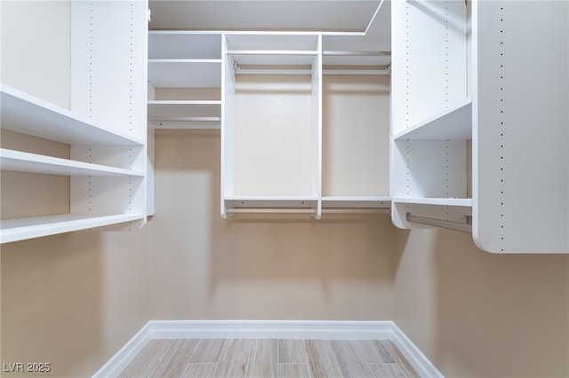 spacious closet with wood finished floors