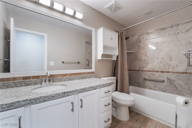 full bathroom with visible vents, toilet, wood tiled floor, shower / bathtub combination with curtain, and vanity