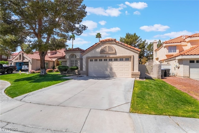 mediterranean / spanish-style house with stucco siding, driveway, a front lawn, an attached garage, and a tiled roof
