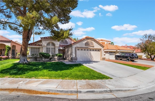 mediterranean / spanish house featuring concrete driveway, stucco siding, a front lawn, a tile roof, and a garage