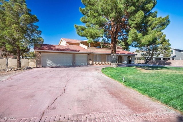 1410 E Serene Ave, Las Vegas, NV 89123 - mediterranean / spanish house featuring a tile roof, a front yard, driveway, and a garage