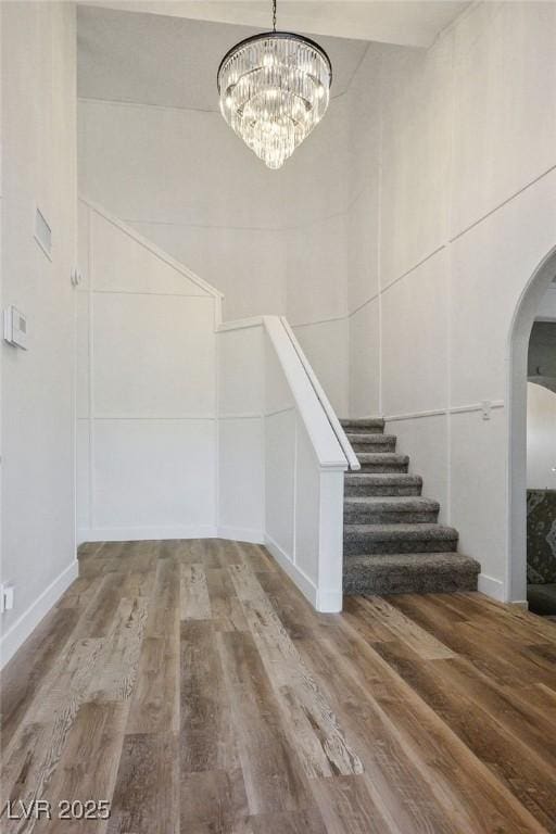 1410 E Serene Ave, Las Vegas, NV 89123 - stairway featuring a chandelier, arched walkways, and wood finished floors