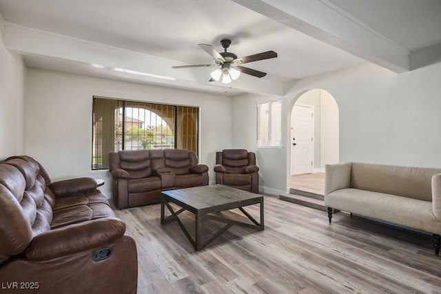 1410 E Serene Ave, Las Vegas, NV 89123 - living room featuring baseboards, arched walkways, ceiling fan, and light wood-style flooring