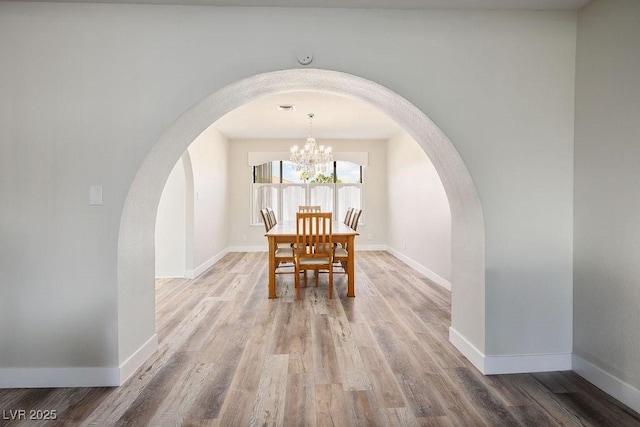 1410 E Serene Ave, Las Vegas, NV 89123 - dining space with wood finished floors, baseboards, and arched walkways