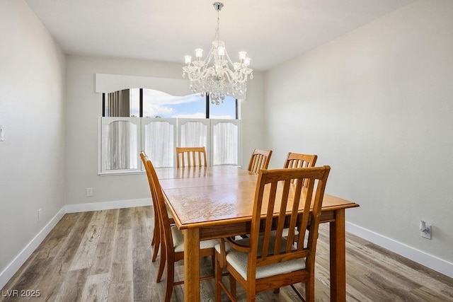 1410 E Serene Ave, Las Vegas, NV 89123 - dining space with a notable chandelier, light wood-style flooring, and baseboards