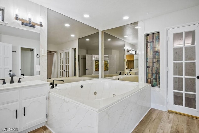 1410 E Serene Ave, Las Vegas, NV 89123 - bathroom with a jetted tub, vanity, wood finished floors, recessed lighting, and a shower