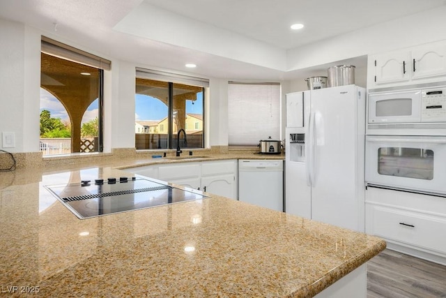 1410 E Serene Ave, Las Vegas, NV 89123 - kitchen featuring white appliances, white cabinets, light stone countertops, recessed lighting, and a raised ceiling