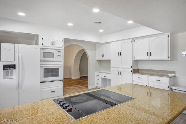 1410 E Serene Ave, Las Vegas, NV 89123 - kitchen with white appliances, white cabinetry, wood finished floors, recessed lighting, and light stone counters