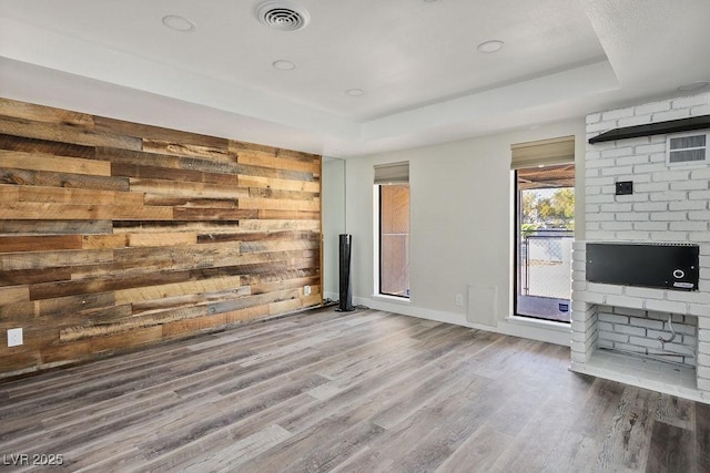 1410 E Serene Ave, Las Vegas, NV 89123 - unfurnished living room featuring a tray ceiling and wood finished floors