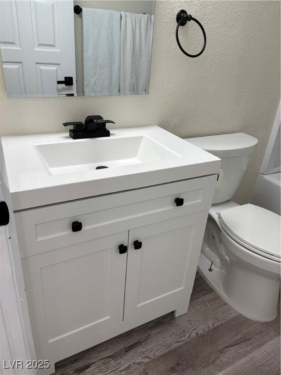 1410 E Serene Ave, Las Vegas, NV 89123 - bathroom featuring a textured wall, vanity, and wood finished floors