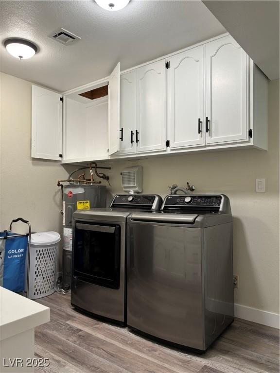 1410 E Serene Ave, Las Vegas, NV 89123 - washroom with washer and dryer, water heater, light wood-type flooring, and cabinet space