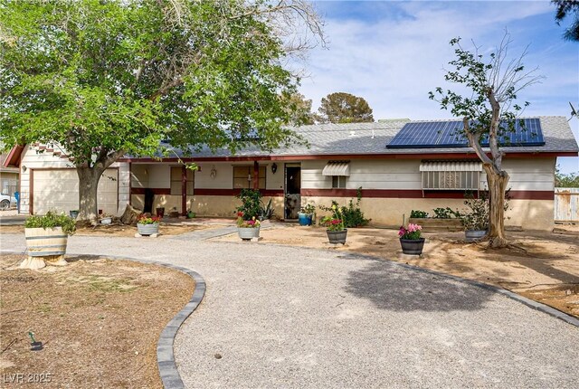 3100 Garehime St, Las Vegas, NV 89108 - ranch-style house featuring solar panels, a garage, and driveway