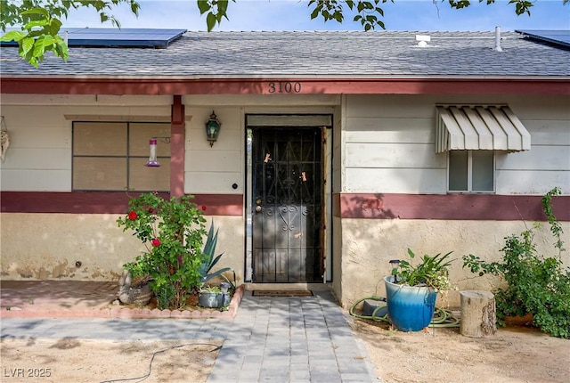 3100 Garehime St, Las Vegas, NV 89108 - entrance to property with a shingled roof and roof mounted solar panels