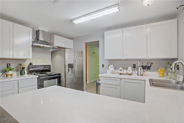 3100 Garehime St, Las Vegas, NV 89108 - kitchen featuring electric range, wall chimney range hood, a sink, stainless steel refrigerator with ice dispenser, and light countertops