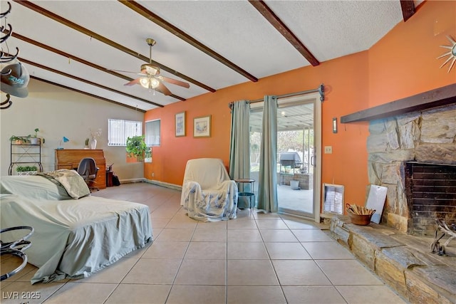 3100 Garehime St, Las Vegas, NV 89108 - living area with ceiling fan, a stone fireplace, plenty of natural light, a textured ceiling, and tile patterned floors