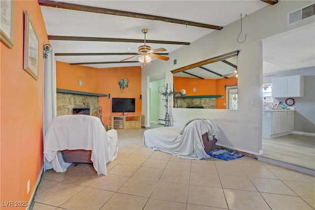 3100 Garehime St, Las Vegas, NV 89108 - tiled living room featuring a fireplace, ceiling fan, baseboards, and washer / dryer
