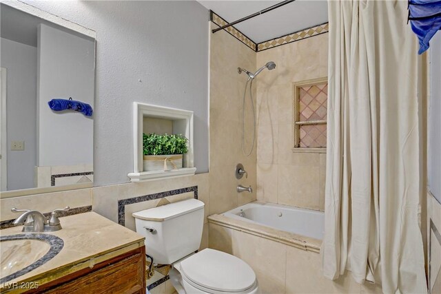 3100 Garehime St, Las Vegas, NV 89108 - bathroom with tiled shower / bath, vanity, toilet, and tile walls
