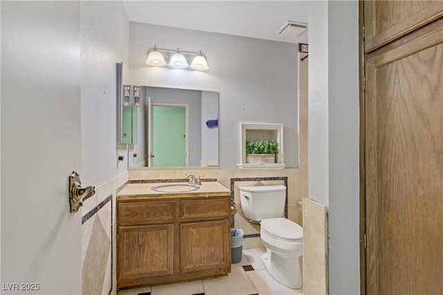 3100 Garehime St, Las Vegas, NV 89108 - bathroom with toilet, vanity, tile patterned flooring, and tile walls