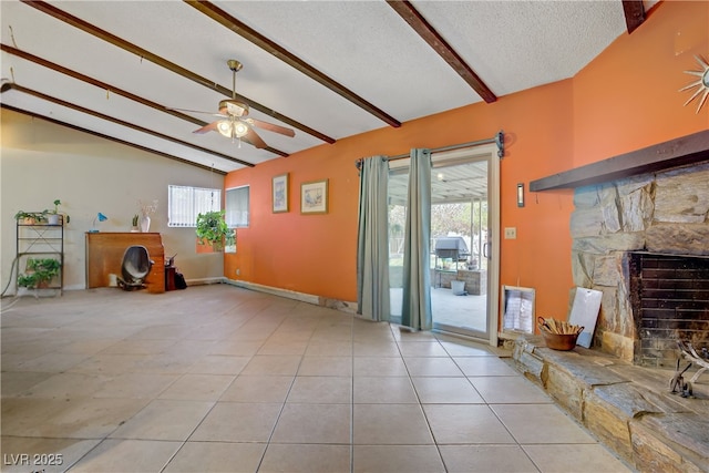 3100 Garehime St, Las Vegas, NV 89108 - unfurnished living room with ceiling fan, a stone fireplace, tile patterned flooring, and a textured ceiling