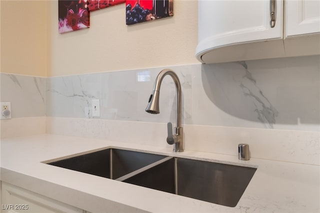 7945 Delbonita Ave, Las Vegas, NV 89147 - room details featuring light stone counters, a sink, and white cabinets