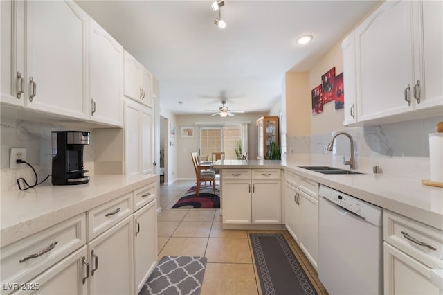 7945 Delbonita Ave, Las Vegas, NV 89147 - kitchen with white dishwasher, a sink, light countertops, backsplash, and light tile patterned flooring