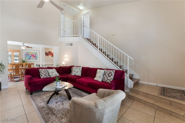 7945 Delbonita Ave, Las Vegas, NV 89147 - tiled living room featuring baseboards, stairway, a ceiling fan, visible vents, and high vaulted ceiling