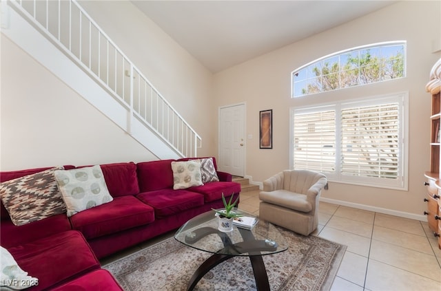 7945 Delbonita Ave, Las Vegas, NV 89147 - living room with stairway, a high ceiling, baseboards, and light tile patterned floors