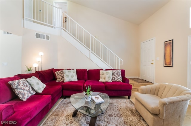 7945 Delbonita Ave, Las Vegas, NV 89147 - tiled living area featuring stairway, visible vents, and a high ceiling