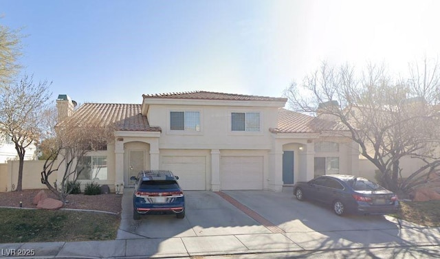 7945 Delbonita Ave, Las Vegas, NV 89147 - mediterranean / spanish home featuring a tile roof, driveway, and stucco siding