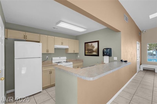 7945 Delbonita Ave, Las Vegas, NV 89147 - kitchen featuring light tile patterned floors, white appliances, a peninsula, visible vents, and light countertops