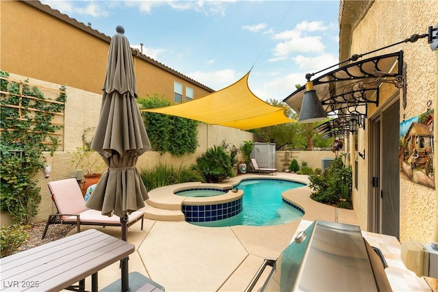 view of pool featuring fence, a patio area, and a pool with connected hot tub