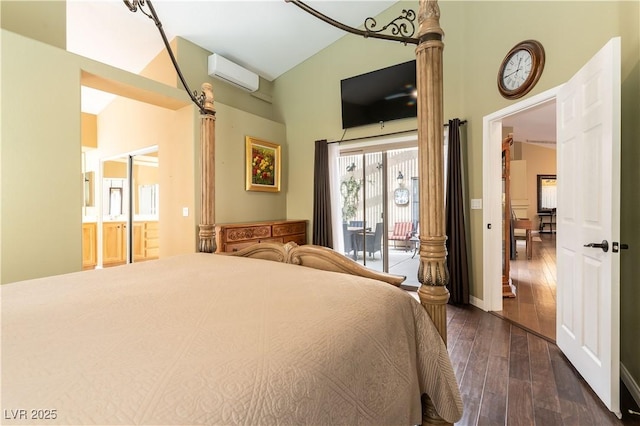 bedroom featuring access to exterior, baseboards, a wall mounted air conditioner, hardwood / wood-style floors, and connected bathroom