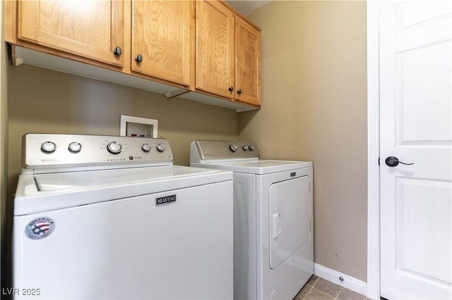 laundry area with cabinet space, washing machine and clothes dryer, baseboards, and light tile patterned flooring