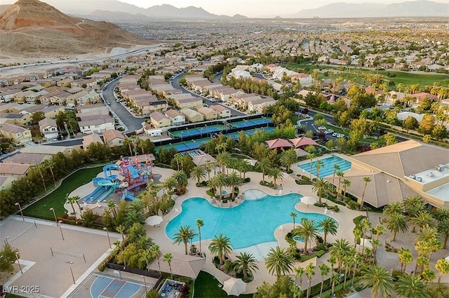 drone / aerial view featuring a residential view and a mountain view