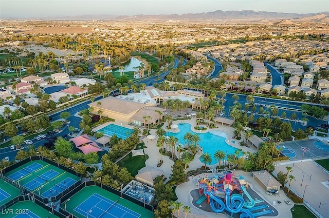 birds eye view of property with a mountain view